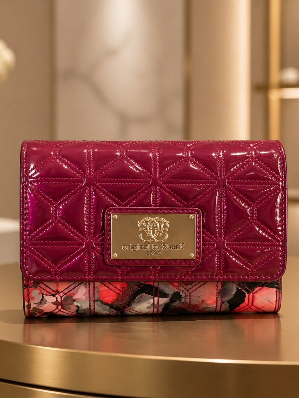 Sharif raspberry patent quilted clutch with floral trim